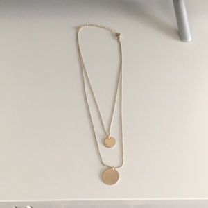Double stranded gold colored disc necklace